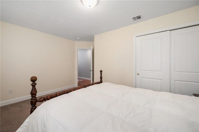 carpeted bedroom featuring a closet and baseboards