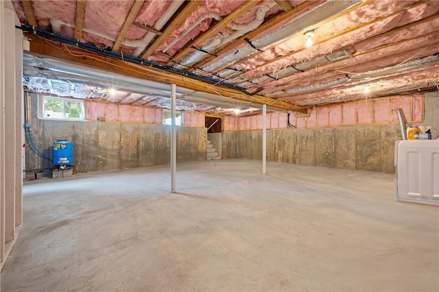 below grade area with a water pressure tank and washer / dryer