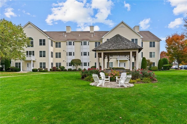 40 Saw Mill Dr Unit 203, North Kingstown, RI 02852 - rear view of house with a gazebo, a yard, a chimney, and a patio area