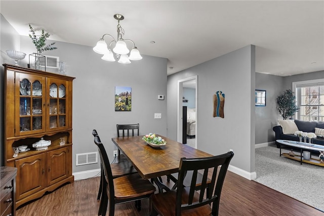 40 Saw Mill Dr Unit 203, North Kingstown, RI 02852 - dining area with a chandelier, baseboards, and dark wood-style floors
