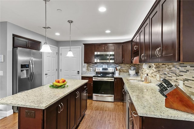 40 Saw Mill Dr Unit 203, North Kingstown, RI 02852 - kitchen featuring stainless steel appliances, light wood finished floors, dark brown cabinets, light stone countertops, and backsplash