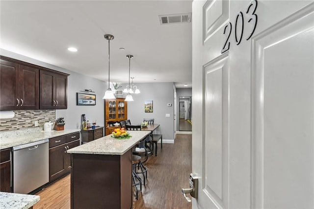 40 Saw Mill Dr Unit 203, North Kingstown, RI 02852 - kitchen featuring stainless steel dishwasher, a kitchen bar, dark brown cabinets, decorative backsplash, and recessed lighting