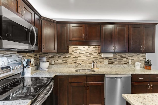 40 Saw Mill Dr Unit 203, North Kingstown, RI 02852 - kitchen featuring appliances with stainless steel finishes, a sink, tasteful backsplash, and dark brown cabinetry