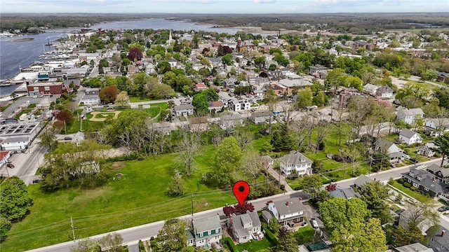 aerial view of property's location with nearby suburban area and a large body of water