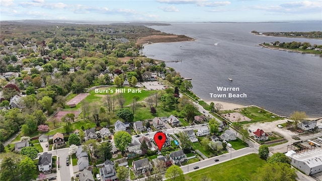 aerial overview of property's location with a nearby body of water and nearby suburban area