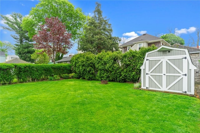 view of green lawn with a storage shed and an outdoor structure