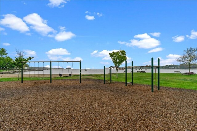view of home's community featuring a lawn and a water view