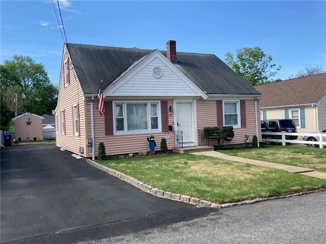30 Charles St, Cranston, RI 02920 - view of front facade featuring a chimney, a front lawn, and a shingled roof