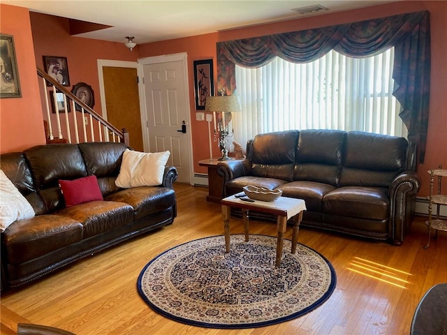 30 Charles St, Cranston, RI 02920 - living room featuring wood finished floors, a baseboard radiator, and stairway