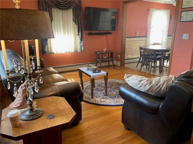 30 Charles St, Cranston, RI 02920 - living area featuring wood finished floors and a baseboard radiator