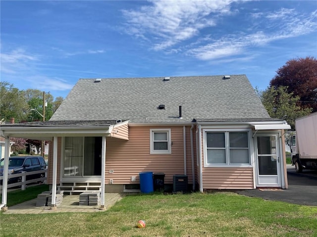 30 Charles St, Cranston, RI 02920 - back of house with a yard, central air condition unit, a shingled roof, and a sunroom