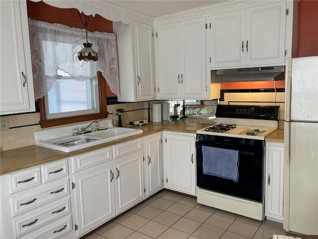 30 Charles St, Cranston, RI 02920 - kitchen featuring gas range oven, freestanding refrigerator, a sink, and white cabinetry