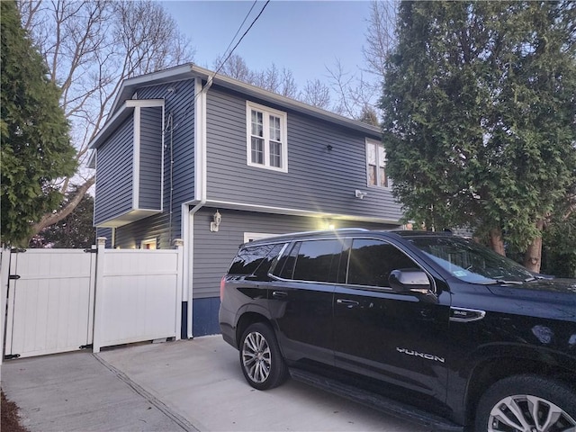 8 Marigold Ct, Cranston, RI 02920 - view of side of property with an attached garage and fence