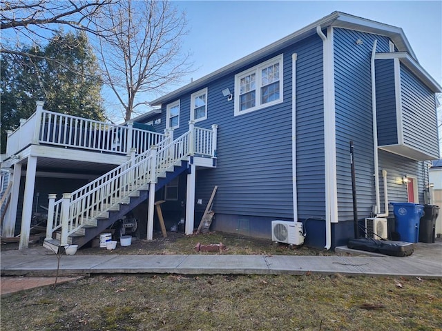 8 Marigold Ct, Cranston, RI 02920 - view of home's exterior featuring ac unit, stairway, a deck, crawl space, and a patio