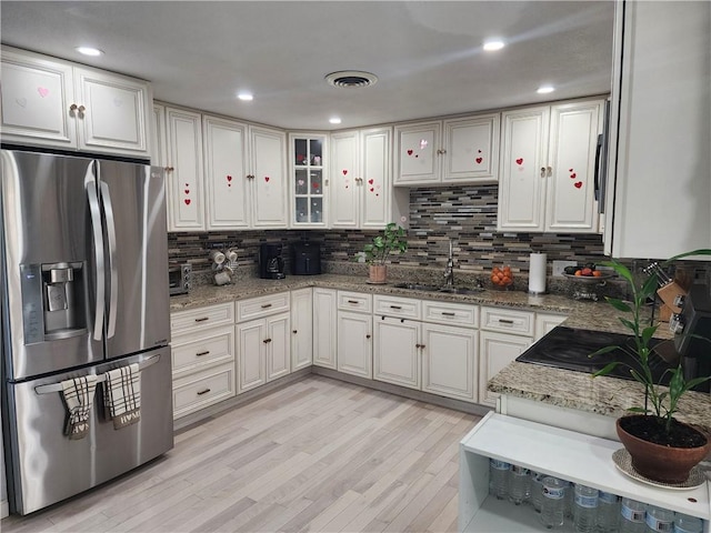 8 Marigold Ct, Cranston, RI 02920 - kitchen featuring stainless steel refrigerator with ice dispenser, a sink, light wood-style flooring, and decorative backsplash