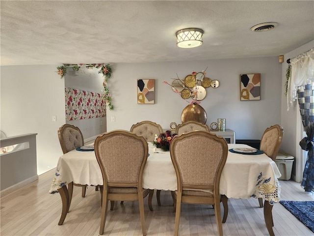 8 Marigold Ct, Cranston, RI 02920 - dining space featuring light wood-style flooring and a textured ceiling