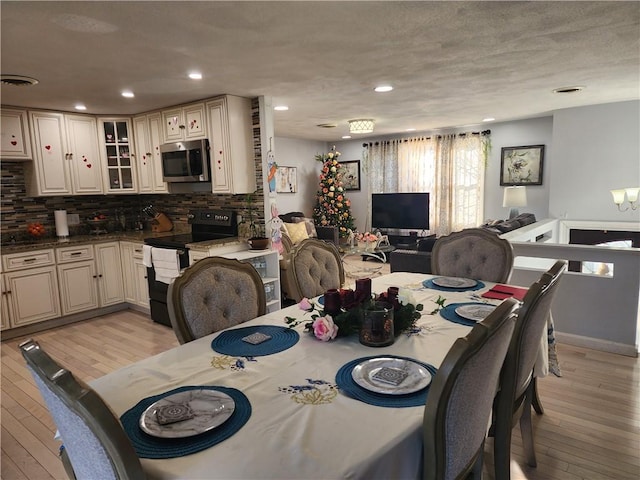 8 Marigold Ct, Cranston, RI 02920 - dining area with light wood-type flooring and recessed lighting