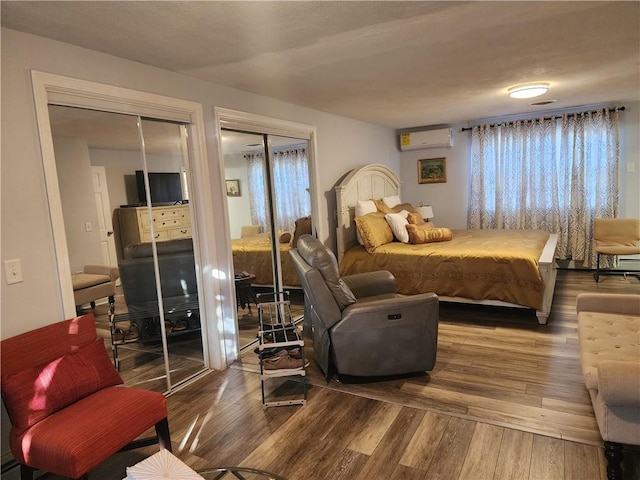 8 Marigold Ct, Cranston, RI 02920 - bedroom with multiple closets, wood finished floors, and a wall mounted air conditioner