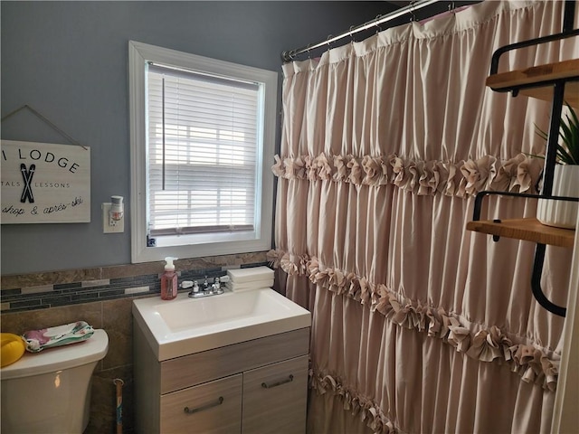 64 Westwood Ave, Cranston, RI 02905 - full bathroom featuring toilet, vanity, tile walls, and a wainscoted wall