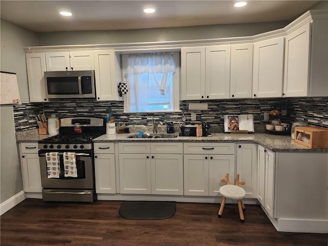 64 Westwood Ave, Cranston, RI 02905 - kitchen featuring appliances with stainless steel finishes, a sink, white cabinetry, tasteful backsplash, and stone countertops