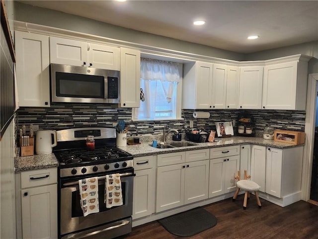 64 Westwood Ave, Cranston, RI 02905 - kitchen with appliances with stainless steel finishes, a sink, tasteful backsplash, white cabinets, and recessed lighting