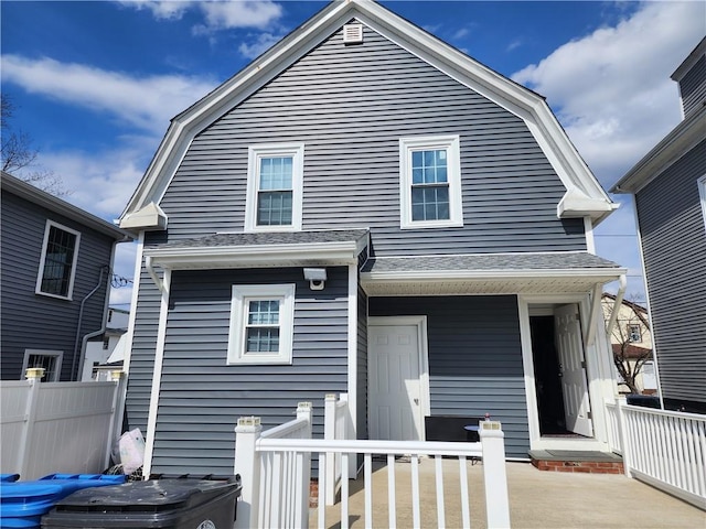 64 Westwood Ave, Cranston, RI 02905 - back of house with a gambrel roof, fence, and a shingled roof