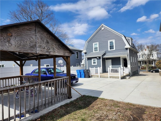 64 Westwood Ave, Cranston, RI 02905 - view of side of property with a gambrel roof and fence