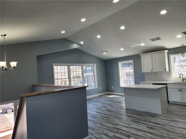 68 Westwood Ave, Cranston, RI 02905 - kitchen with a center island, a chandelier, a sink, backsplash, and dark wood finished floors