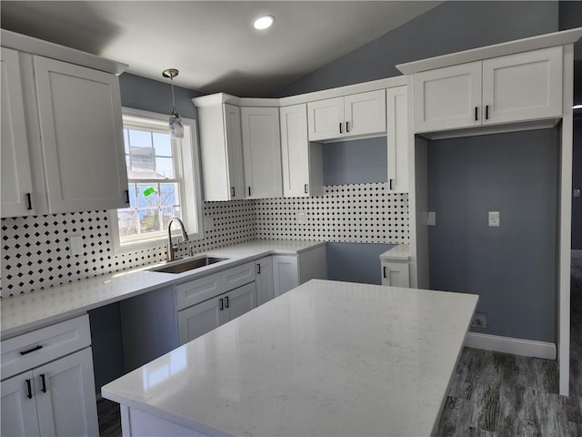 68 Westwood Ave, Cranston, RI 02905 - kitchen featuring a sink, backsplash, lofted ceiling, light stone countertops, and dark wood-style floors