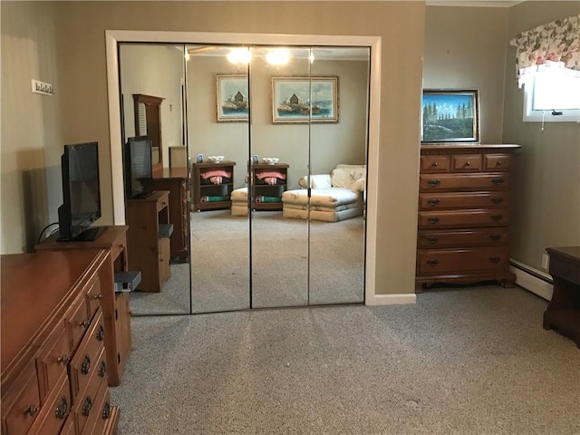 bedroom featuring carpet floors, a closet, and baseboard heating