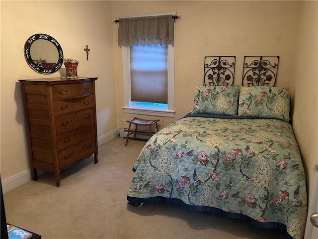 bedroom with a baseboard radiator, carpet, and baseboards