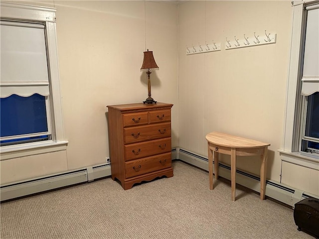 bedroom with light carpet and a baseboard radiator