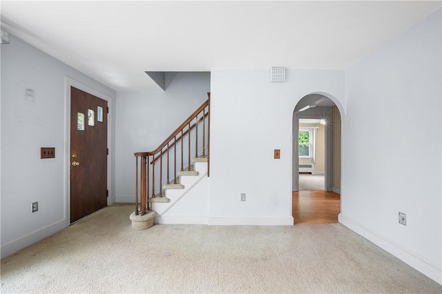11 Homestead St, Smithfield, RI 02917 - carpeted entryway featuring arched walkways, baseboards, and stairway