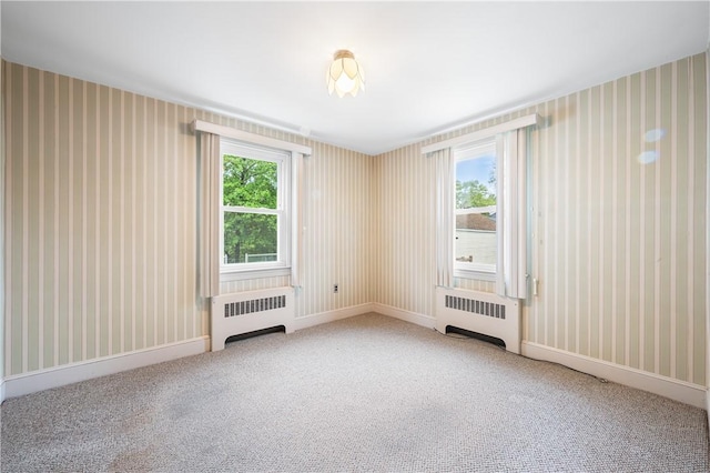 11 Homestead St, Smithfield, RI 02917 - carpeted empty room with radiator heating unit, wallpapered walls, healthy amount of natural light, and baseboards