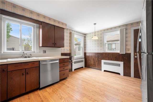 11 Homestead St, Smithfield, RI 02917 - kitchen featuring stainless steel appliances, radiator, wallpapered walls, a sink, and light wood-style floors