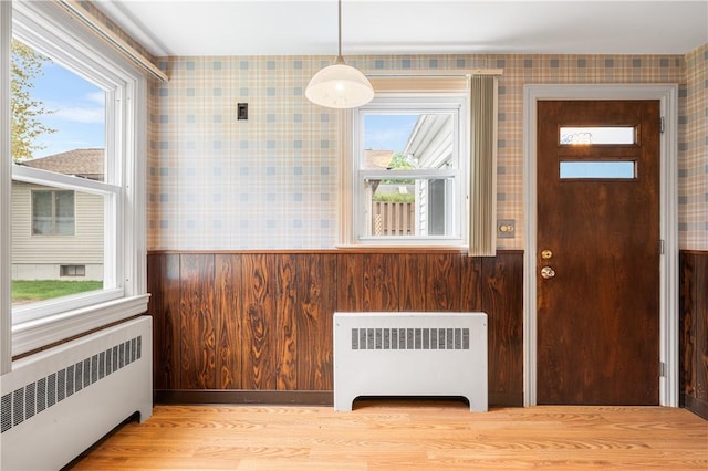 11 Homestead St, Smithfield, RI 02917 - foyer entrance with radiator, wallpapered walls, plenty of natural light, and a wainscoted wall
