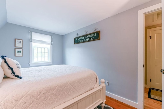 bedroom with wood finished floors and baseboards