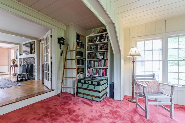 living area with carpet flooring and a brick fireplace