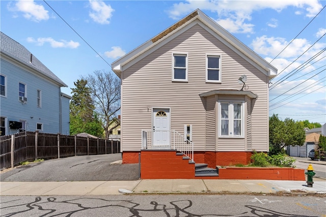 rear view of property featuring fence