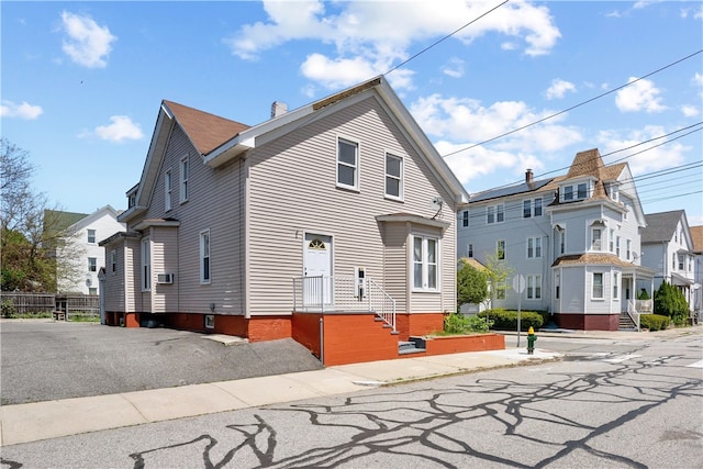 view of front of house featuring a residential view and a chimney