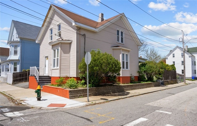 view of property exterior featuring fence and a chimney