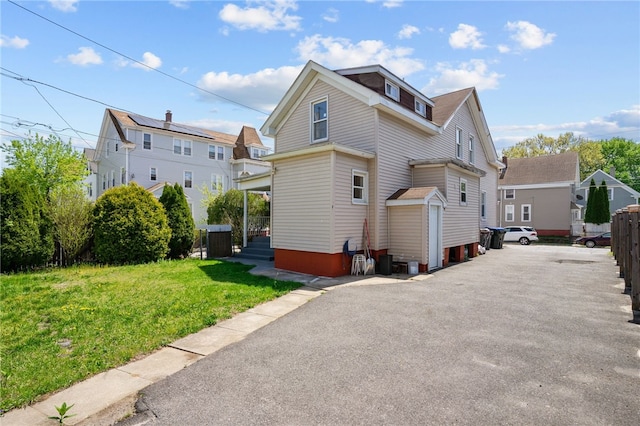 rear view of house with a lawn