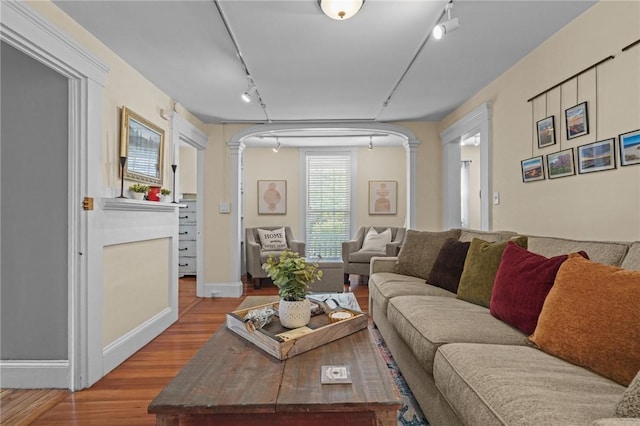 275 Hope St, Bristol, RI 02809 - living area with rail lighting, ornate columns, wood finished floors, and baseboards