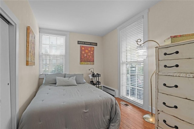 275 Hope St, Bristol, RI 02809 - bedroom with baseboard heating and wood finished floors