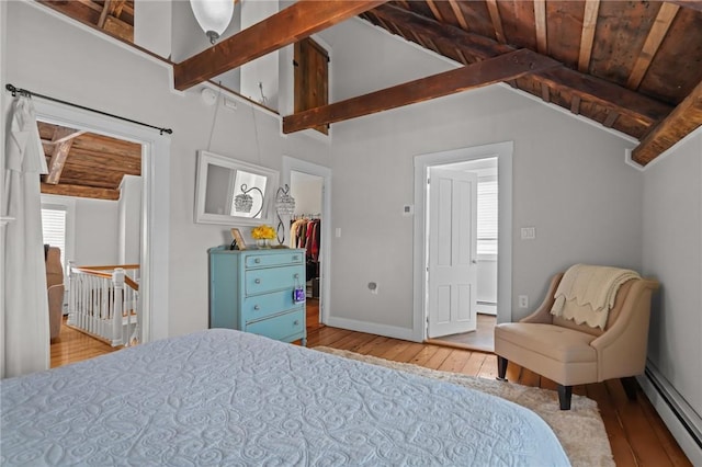275 Hope St, Bristol, RI 02809 - bedroom with hardwood / wood-style flooring, a baseboard heating unit, a spacious closet, and baseboards