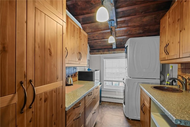 275 Hope St, Bristol, RI 02809 - clothes washing area featuring wood ceiling, baseboard heating, stacked washer and clothes dryer, and dark tile patterned floors
