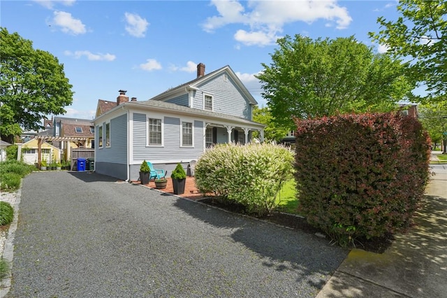 275 Hope St, Bristol, RI 02809 - view of side of home with a chimney and driveway