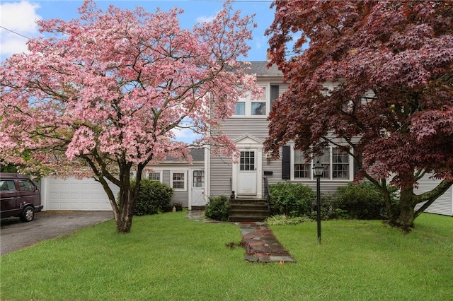 35 Miles Ave, East Providence, RI 02914 - view of front facade featuring driveway, a front lawn, and a garage