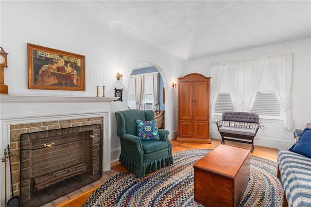 35 Miles Ave, East Providence, RI 02914 - sitting room with wood finished floors, a fireplace with flush hearth, arched walkways, and baseboards
