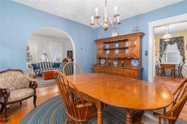 35 Miles Ave, East Providence, RI 02914 - dining room featuring arched walkways, a chandelier, and light wood finished floors